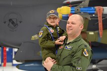 Capt. Jonathan Martin, 334th Fighter Squadron pilot instructor, embraces Alexis “Crusher” Chamberlain, a seven-year-old girl recently diagnosed with leukemia, during a Pilot for a Day program event, Feb. 15, 2017, at Seymour Johnson Air Force Base, North Carolina. Alexis toured the fighter squadron, sat in an F-15E Strike Eagle and received memorabilia and gifts during her visit. (U.S. Air Force photo by Airman Miranda A. Loera)