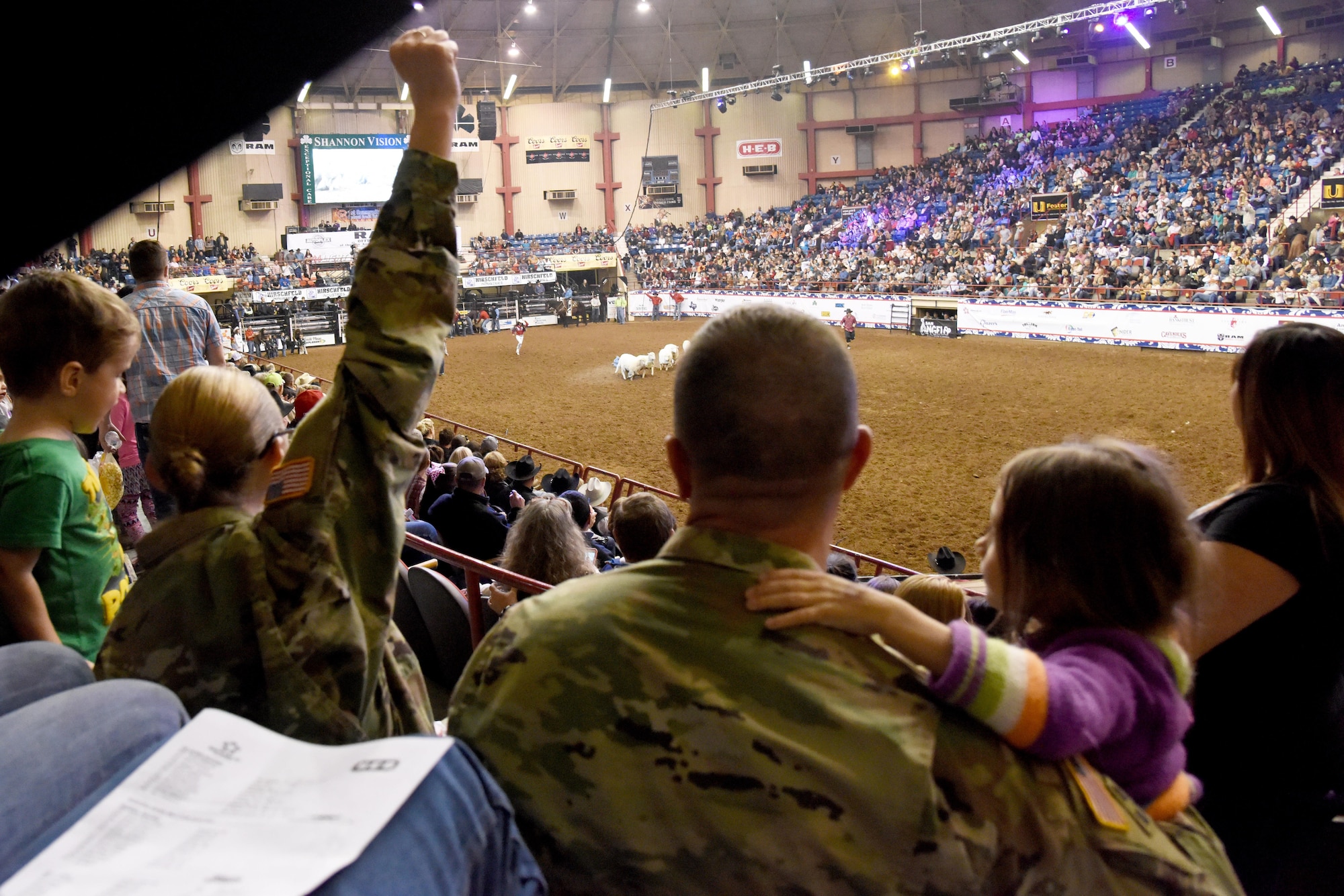 Soldiers watch the mutton busting during the 85th Annual San Angelo Stock Show and Rodeo Military Appreciation Night at the Foster Communications Coliseum in San Angelo, Texas, Feb. 15, 2017. Mutton busting is a rodeo event where children ride bucking sheep. (U.S. Air Force photo by Staff Sgt. Joshua Edwards/Released)