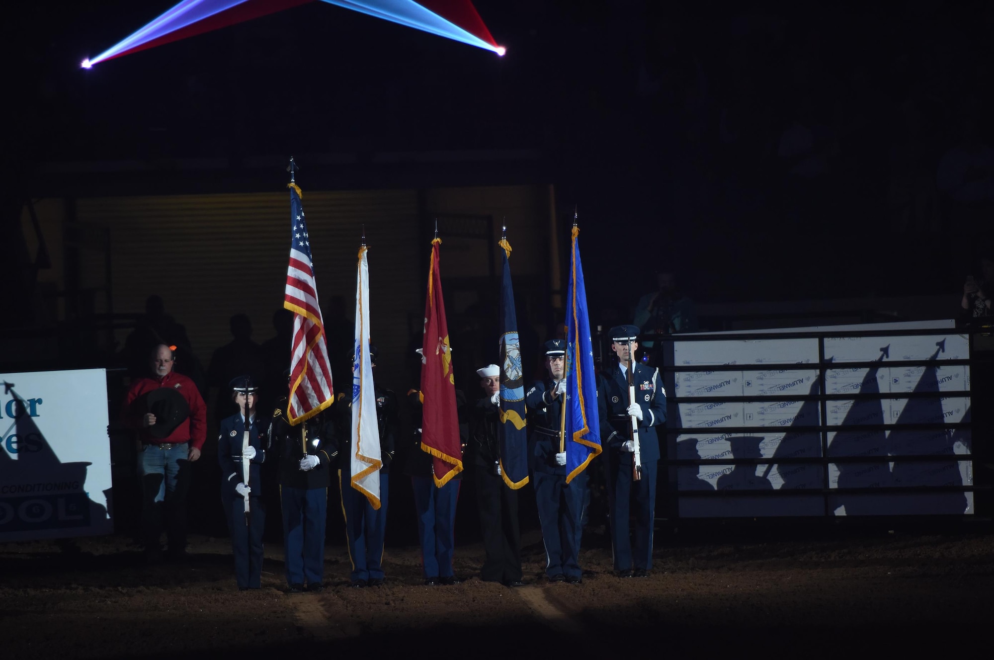 The Goodfellow Air Force Base Joint-Service Color Guard present the colors during the 85th Annual San Angelo Stock Show and Rodeo Military Appreciation Night at the Foster Communications Coliseum in San Angelo, Texas, Feb. 15, 2017. Goodfellow Air Force Base’s Patriotic Blue sang "The Star-Spangled Banner" during the presentation of the colors. (U.S. Air Force photo by Staff Sgt. Laura R. McFarlane/Released)