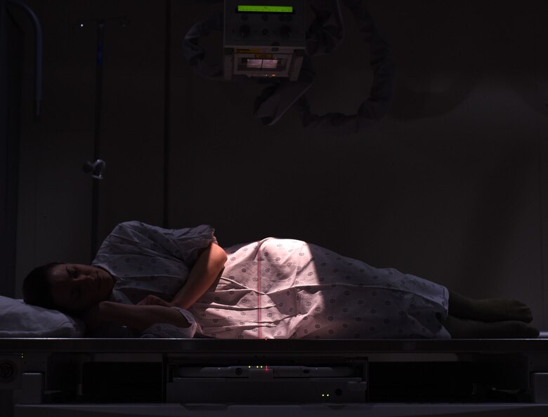 A patient lays on a therapeutic x-ray table at the 341st Medical Support Squadron radiology clinic Feb. 15, 2017, at Malmstrom Air Force Base, Mont. The radiology clinic is critical in producing the highest quality x-ray images to assist providers in accurately diagnosing a patient through the use of radiographs. (U.S. Air Force photo/Senior Airman Jaeda Tookes)