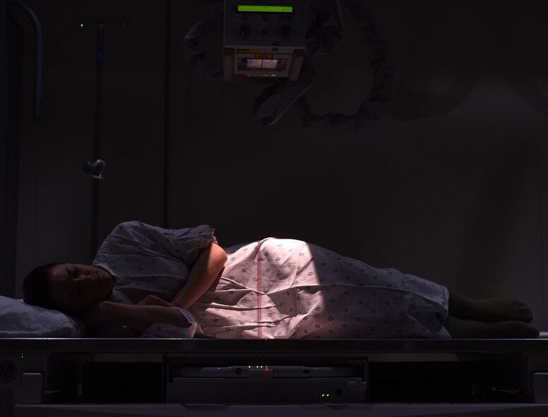 A patient lays on a therapeutic x-ray table at the 341st Medical Support Squadron radiology clinic Feb. 15, 2017, at Malmstrom Air Force Base, Mont. The radiology clinic is critical in producing the highest quality x-ray images to assist providers in accurately diagnosing a patient through the use of radiographs. (U.S. Air Force photo/Senior Airman Jaeda Tookes)