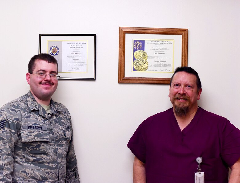 Staff Sgt. Jason Spearow, 341st Medical Support Squadron NCO in charge of diagnostic imaging, left, and Lee Weideman, 341st Medical Support Squadron radiological senior technician, pose for a photo Feb. 15, 2017, at Malmstrom Air Force Base, Mont. Spearow and Weideman are both nationally registered radiology technicians through the American Registry of Radiologic Technologists. (U.S. Air Force photo/Senior Airman Jaeda Tookes)