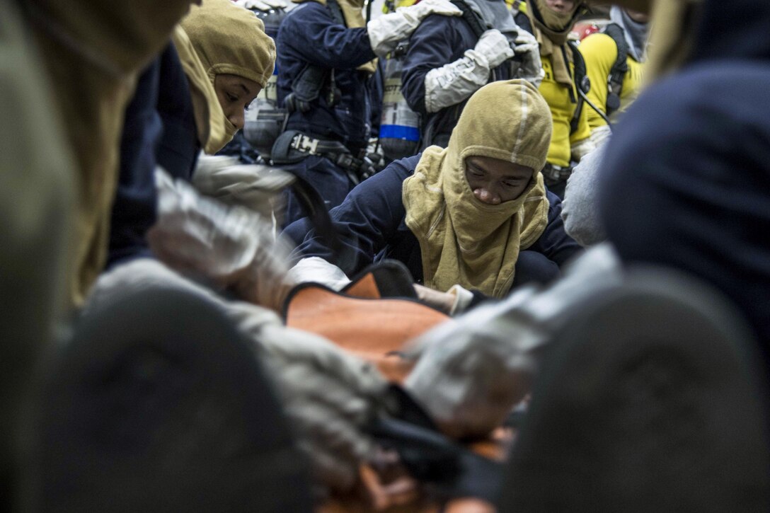 Sailors treat a simulated personnel casualty on the USS Dwight D. Eisenhower during a drill in the Pacific Ocean, Feb. 14, 2017. Navy photo by Petty Officer 3rd Class Nathan T. Beard