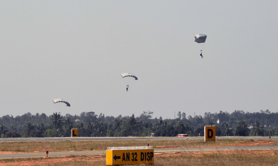 U.S. and India Special Forces paratroopers descend from a U.S. Air Force C-130J Super Hercules following a joint U.S. and India combined free-fall jump during Aero India 2017 at Air Force Station Yelahanka, Bengaluru, India, Feb. 15, 2017. The jump was one of the highlights of the tradeshow that demonstrates the U.S. commitment to the security of the Indo-Asia-Pacific region, promotes the standardization and interoperability of equipment, and displays capabilities critical to the success of current and future military operations. (U.S. Air Force photo by Capt. Mark Lazane)

