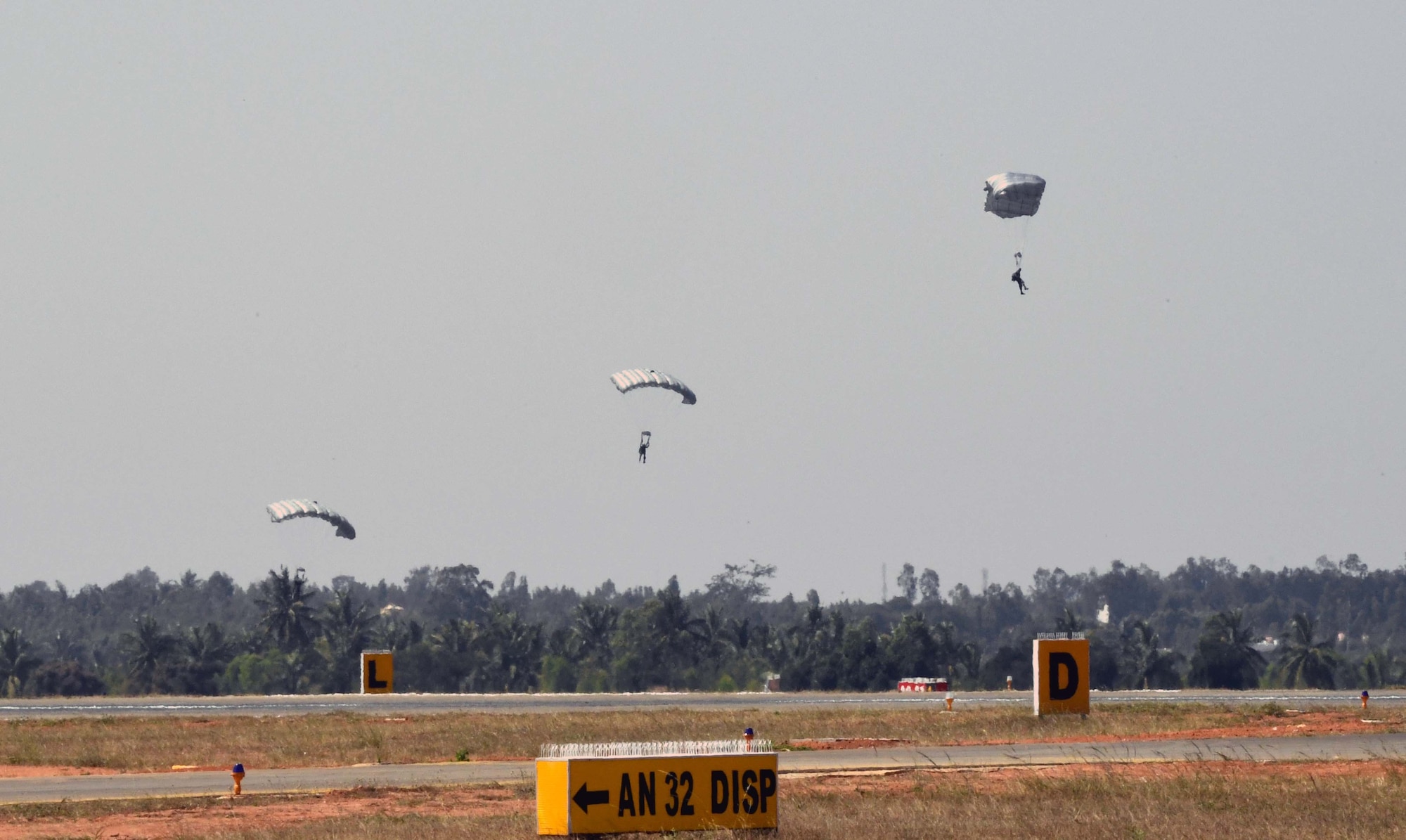U.S. and India Special Forces paratroopers descend from a U.S. Air Force C-130J Super Hercules following a joint U.S. and India combined free-fall jump during Aero India 2017 at Air Force Station Yelahanka, Bengaluru, India, Feb. 15, 2017. The jump was one of the highlights of the tradeshow that demonstrates the U.S. commitment to the security of the Indo-Asia-Pacific region, promotes the standardization and interoperability of equipment, and displays capabilities critical to the success of current and future military operations. (U.S. Air Force photo by Capt. Mark Lazane)

