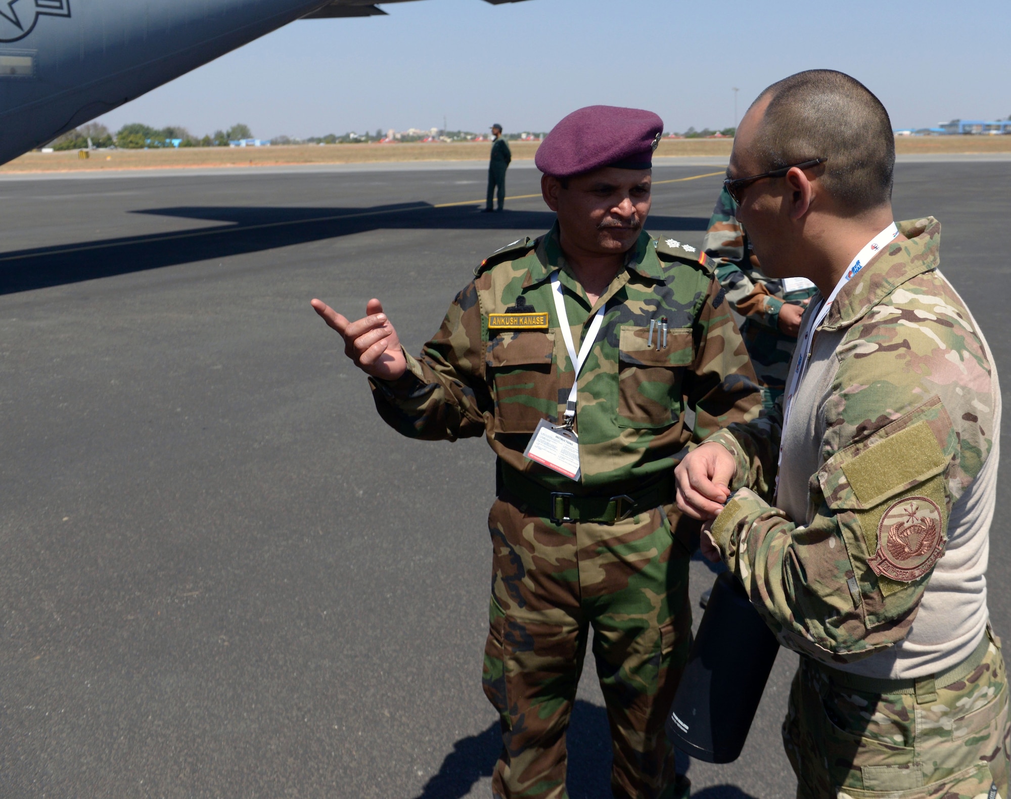 U.S. Air Force and Indian Air Force drop-zone coordinators consult on safety tactics prior to a joint U.S. and India Special Forces combined free-fall jump from a U.S. Air Force C-130J Super Hercules at Air Force Station Yelahanka, Bengaluru, India, Feb. 15, 2017. The U.S. participates in air shows and other regional events to demonstrate its commitment to the security of the Indo-Asia-Pacific region, promote the standardization and interoperability of equipment, and display capabilities critical to the success of current and future military operations. (U.S. Air Force photo by Capt. Mark Lazane)

