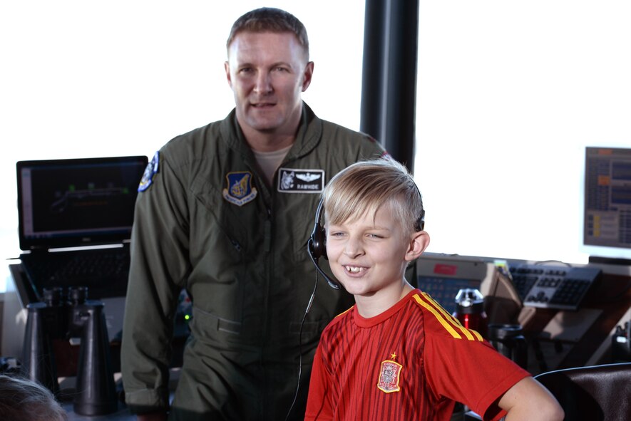 A child conducts a communications check for his father before he takes off down the runway Feb. 12, 2017, at Eielson Air Force Base, Alaska. His father, a pilot with the 18th Aggressor Squadron was leaving for COPE NORTH 2017, a multilateral exercise including roughly 1,700 members of United States Air Force and Navy, Japan Air Self-Defense Force, and Royal Australian Air Force. (U.S. Air Force Photo by Airman Eric M. Fisher)