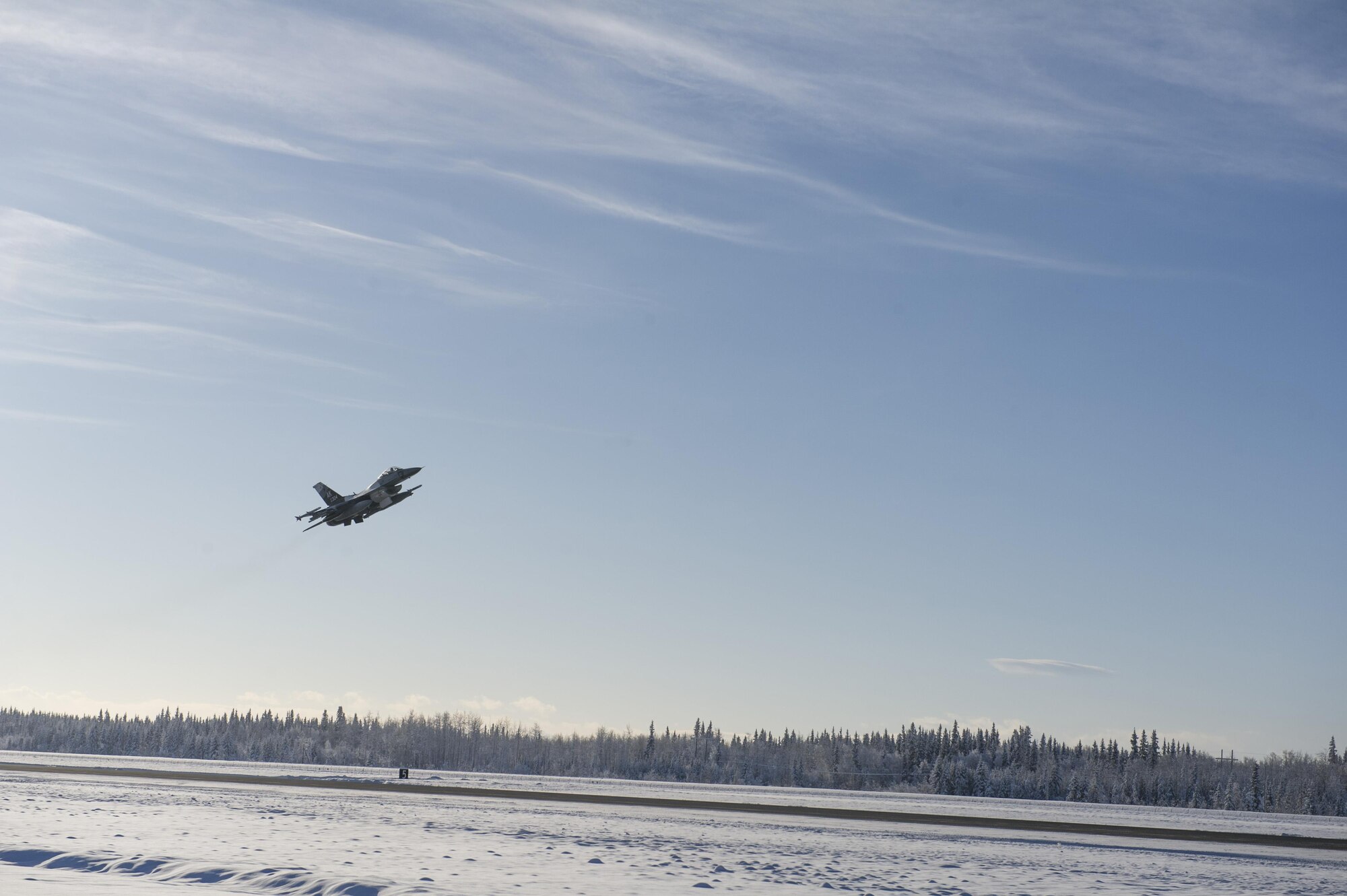 A U.S. Air Force F-16 Fighting Falcon aircraft assigned to the 18th Aggressor Squadron, takes off from the Eielson Air Force Base, Alaska, flight line Feb. 12, 2017. Members of the 18th AGRS began their journey to Andersen Air Force Base, Guam, in support of COPE NORTH 2017 which is an exercise that prepares U.S. and coalition forces for possible contingency operations. (U.S. Air Force photo by Airman Isaac Johnson)