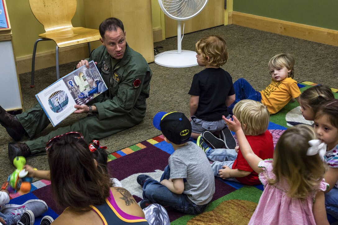 Marine Corps Maj. Benjamin D. Apple reads "Violet Pilot," an aviation-themed children's book, to families at a public library in Yuma, Ariz., Feb. 15, 2017. Apple is the operations officer for Marine Fighter Training Squadron 401. Marine Corps photo by Lance Cpl. Christian Cachola