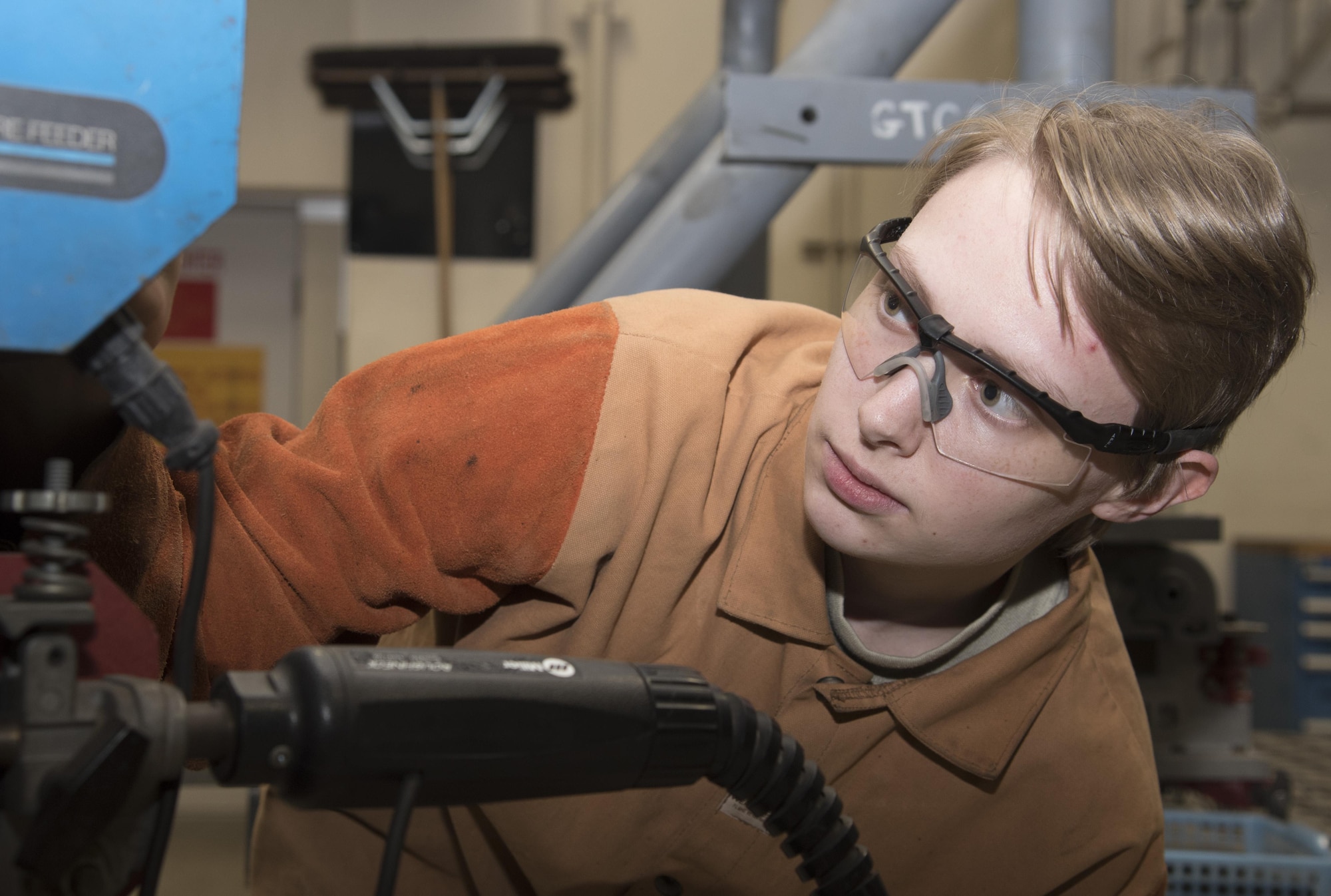 U.S. Air Force Airman 1st Class Elfie Diltz, a 35th Maintenance Squadron aircraft metals technology technician, turns a wire speed dial at Misawa Air Base, Japan, Feb. 1, 2017. The dial controls how fast it feeds metal into a CP-300 gas metal arc welder, providing extra material to bind other parts together. The flight repairs metal for the F-16 Fighting Falcon, ensuring its power projection across the Indo-Asian Pacific region. (U.S. Air Force photo by Airman 1st Class Sadie Colbert)