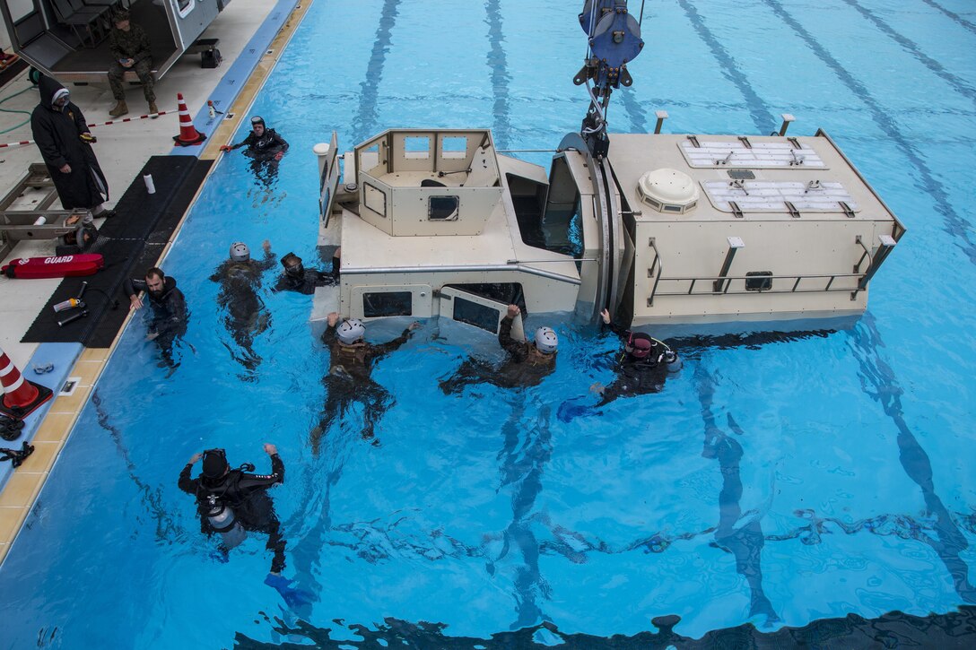 U.S. Marines with Truck Company, Headquarters Battalion, 3rd Marine Division, III Marine Expeditionary Force, escape from a Submerged Vehicle Egress Trainer on Camp Hansen, Okinawa, Japan, Feb. 9, 2017. Marines with Truck Company are required to complete Underwater Egress Training as part of their pre-deployment training for Fuji Viper 17-3. (U.S. Marine Corps photo by MCIPAC Combat Camera Lance. Cpl. Jesus McCloud)