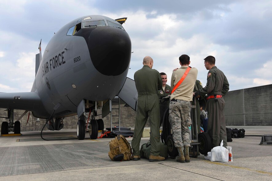 An aircrew from the 909th Air Refueling Squadron discuss pre-flight details Feb. 13, 2017, at Kadena Air Base, Japan. KC-135 Stratotankers from Kadena flew to Anderson Air Force Base, Guam, to participate in the 88th iteration of Cope North, an annual exercise that enables regional forces to train together to enhance readiness and war-fighting integration. (U.S. Air Force photo by SrA John Linzmeier)