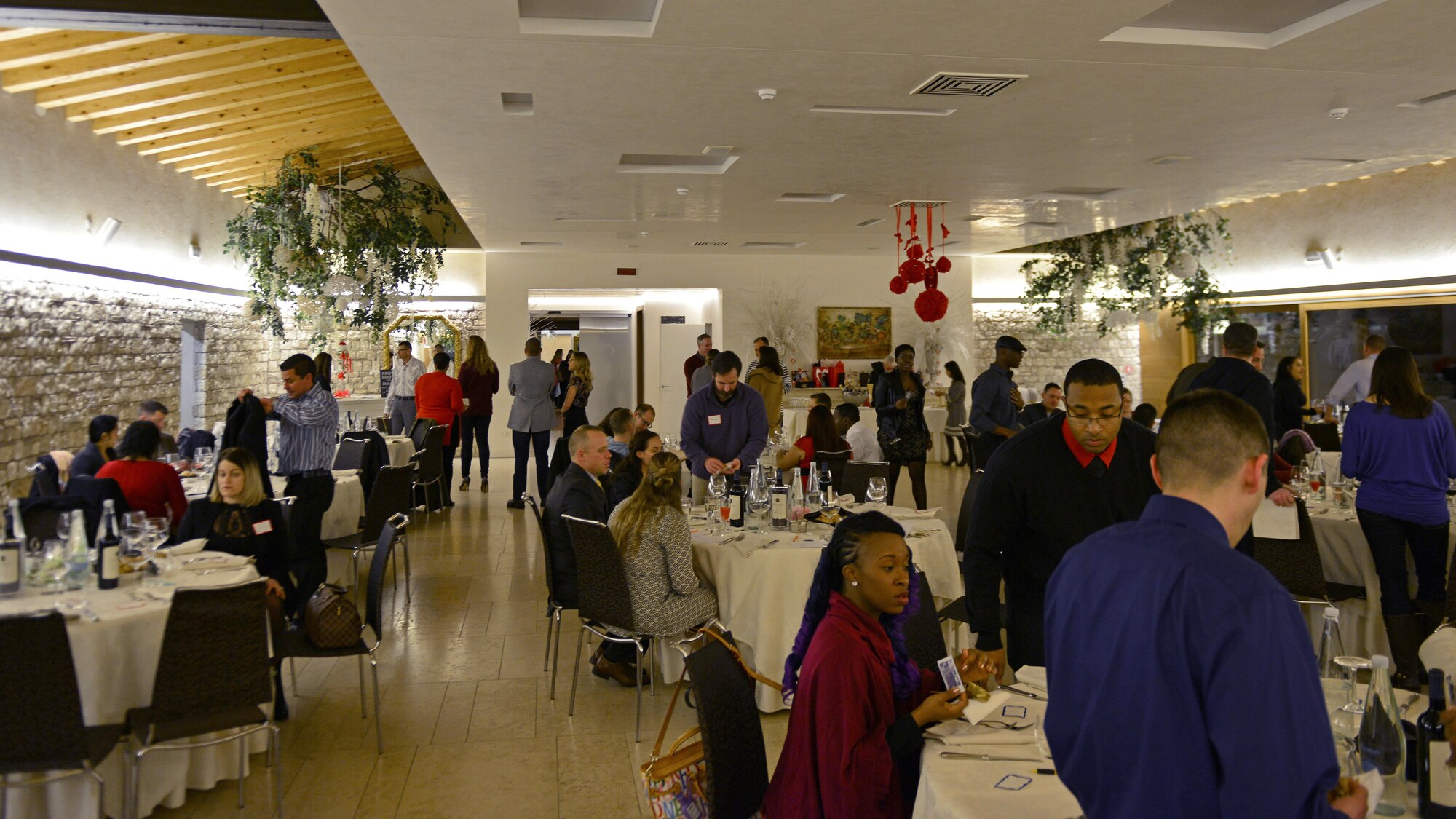 Couples mingle and find their seats before a “Forever For Real” event in Polcenigo, Italy, Feb. 11, 2017. The event, hosted by the base chapel and Airman and Family Readiness Center, consisted of a five-course meal and an interactive discussion about finances. (U.S. Air Force photo by Senior Airman Cary Smith)