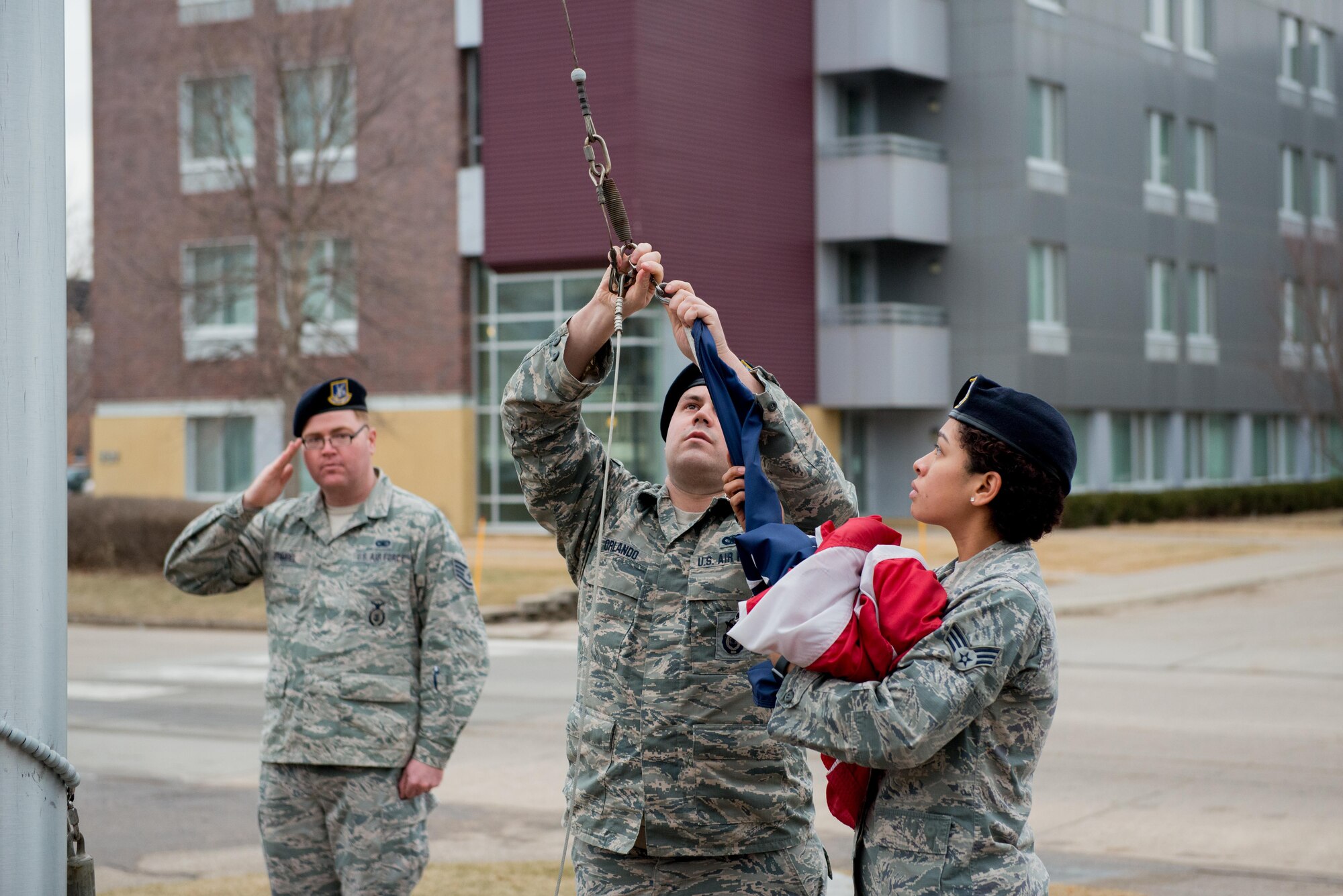 Members of the 934th Security Forces Squadron gather the flag during Retreat on Feb 11, 2017 signaling the end of the official duty day. (U.S. Air Force photo by Senior Airman Samuel Wacha)