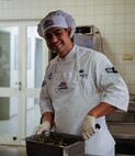 Airman 1st Class Efrain Torres, 786th Force Support Squadron food services journeyman, prepares a side dish at the Rheinland Dining Facility on Ramstein Air Base, Germany, Feb. 13, 2017. Between the Rheinland Dining Facility, Lindberghof Dining Facility and the Jawbone Flight Kitchen, more than 290,000 meals were locally served in 2016. (U.S. Air Force photo by Airman 1st Class Savannah L. Waters)
