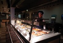 Adina Georgescu, Rheinland Inn Facility cook, checks the food line before lunch for cleanliness and order at the Rheinland Dining Facility on Ramstein Air Base, Germany, Feb. 13, 2017. The 786th Force Support Squadron supports a population of more than 9,000 Airmen, American civilians, local nationals, and staff from more than three dozen countries. (U.S. Air Force photo by Airman 1st Class Savannah L. Waters)
