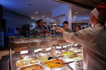 A dining facility customer takes a plate of food from Senior Airman Kelsey Palmer, 786th Force Support Squadron chef leader, at the Rheinland Dining Facility on Ramstein Air Base, Germany, Feb. 13, 2017. Last year, the 786th Force Support Squadron supported more than 1,900 professional military education students and 1,200 essential station messing Airmen. (U.S. Air Force photo by Airman 1st Class Savannah L. Waters)