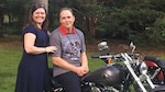 John Bryant, a quality assurance specialist with Defense Contract Management Agency International in Ottawa, Canada, is presented with a Harley Davidson Breakout from his wife, July 4, 2016. The motorcycle was a gift in celebration of his successful battle against cancer. (Photo courtesy of Patrick Norton)