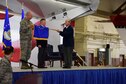 12th Flying Training Wing Commander, Col. Joel Carey unfurls the 12th Maintenance Group&#39;s organizational flag with the group&#39;s director, Robert West and the the group&#39;s deputy director Robert Hamm during an activation ceremony Feb. 10 at Joint Base San Antonio - Randolph, Texas.  The group is the first civil service maintenance directorate in Air Education and Training Command to reorganize as a group.  (U.S. Air Force photo by Randy Martin) 