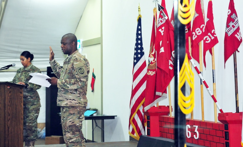 Senior Enlisted Advisor of the 863rd Engineer Battalion Command Sgt. Maj. Samuel E. Carr and native of Waukesha, Wis., administers the Non-Commissioned Officer oath to the 100 Soldiers participating in the NCO Induction Ceremony, which signifies the transition from enlisted to the rank of Sergeant at Camp Buerhing, Kuwait, Dec. 8, 2016.  (Photo by U.S. Army National Guard Capt. Maria Mengrone/Released)