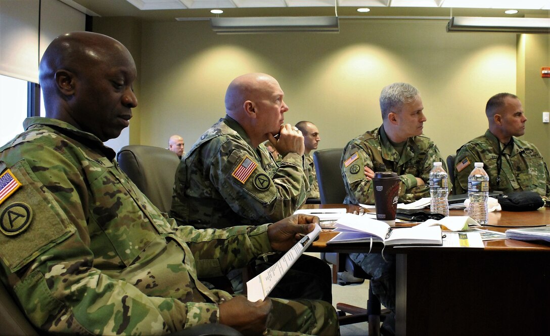 (Left to Right) Command Sgt. Maj. Ronnie Farmer, command sergeant major for the 335th Signal Command (Theater), Maj. Gen. Pete Bosse, commanding general, for the 335th SC (T), Col. Michael D. Smith, commander of the U.S. Army Reserve Cyber Operations Group, and Command Sgt. Maj. Timothy Eddy, command sergeant major for the ARCOG, review readiness data being presented to them during a command brief, Jan 7 at the ARCOG headquarters in Adelphi, Maryland. The purpose was for Bosse to review and give feedback on the readiness and training status for the ARCOG. (U.S. Army Reserve Photo by Sgt. Erick Yates)