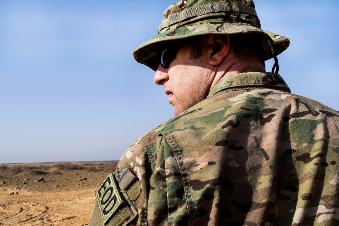 Air Force Master Sgt. Neil Gertiser observes and supervises airmen preparing to detonate unserviceable bombs at a range in Southwest Asia, Feb. 11, 2017. Gertiser is an explosive ordnance disposal technician assigned to the 332nd Expeditionary Civil Engineer Squadron. Air Force photo by Staff Sgt. Eboni Reams