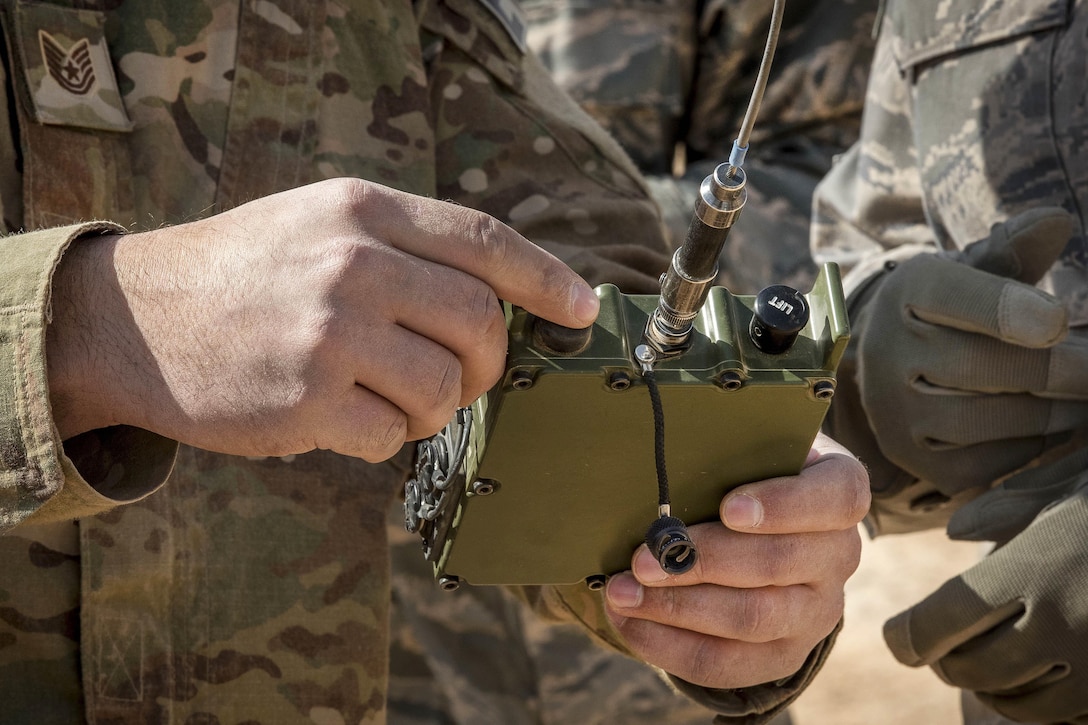 Air Force Tech. Sgt. Michael Stuenzi explains to an airman how to operate a remote firing device transmitter in preparation for the disposal of unservicable ordnance in Southwest Asia, Feb. 11, 2017. Stuenzi is an explosive ordnance disposal technician assigned to the 332nd Expeditionary Civil Engineer Squadron. Air Force photo by Staff Sgt. Eboni Reams