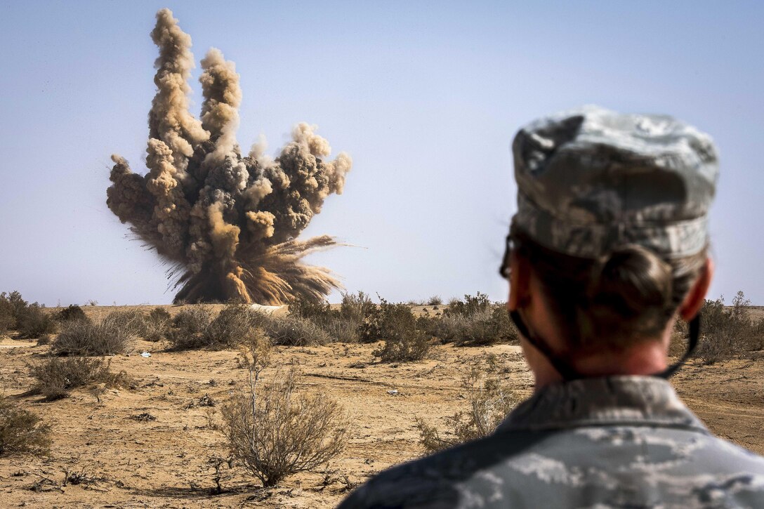 Air Force Master Sgt. Victoria Kenny detonates unserviceable explosives at a range in Southwest Asia, Feb. 11, 2017. Kenny is the first sergeant for the 332nd Expeditionary Civil Engineer Squadron. Air Force photo by Staff Sgt. Eboni Reams