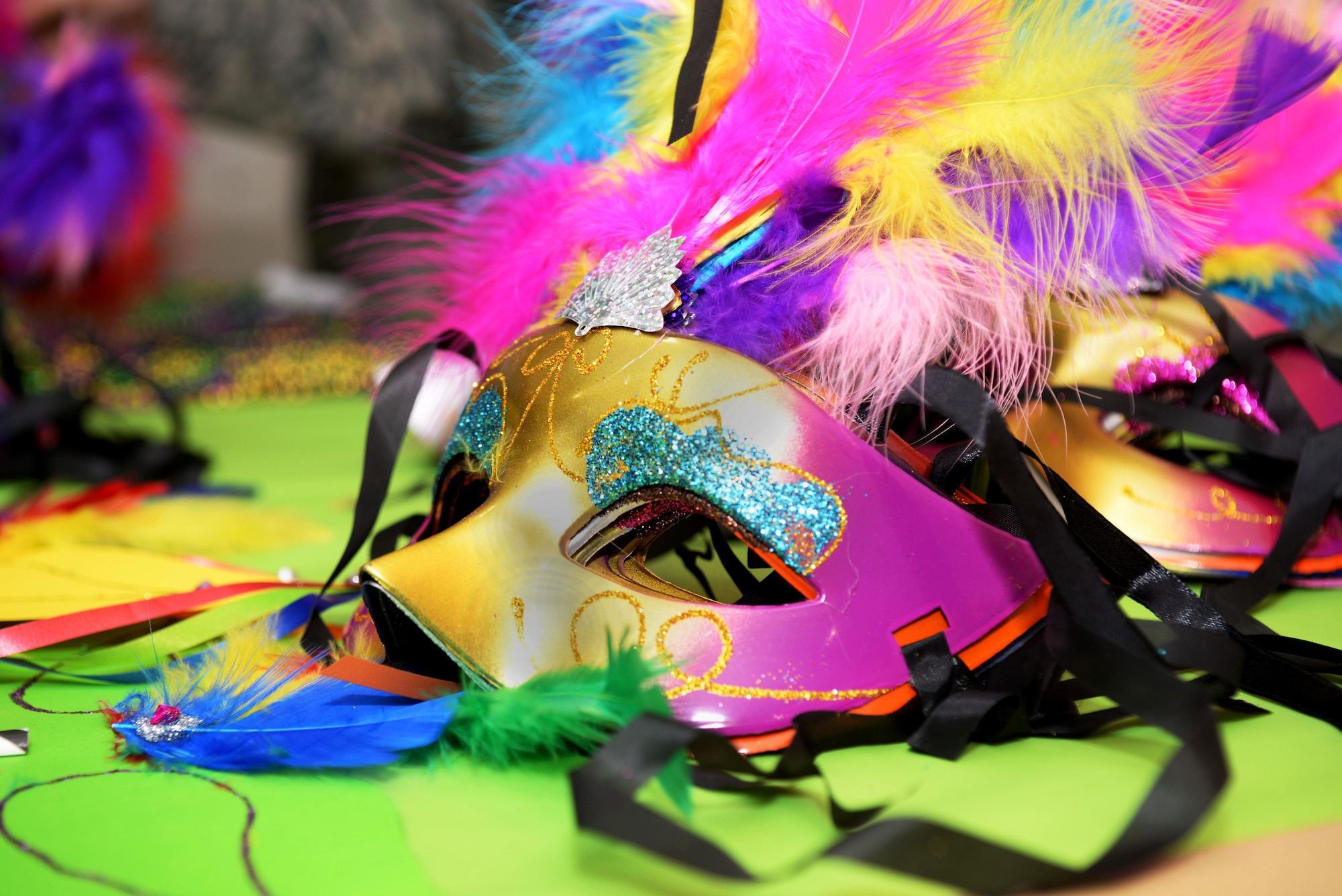 A mask sits on the table during the Hearts Apart event Feb. 16, 2017, on RAF Mildenhall, England. This month’s Hearts Apart event was a “Mardi Gras” theme, including a photo booth complete with props. (U.S. Air Force photo by Airman 1st Class Tenley Long)