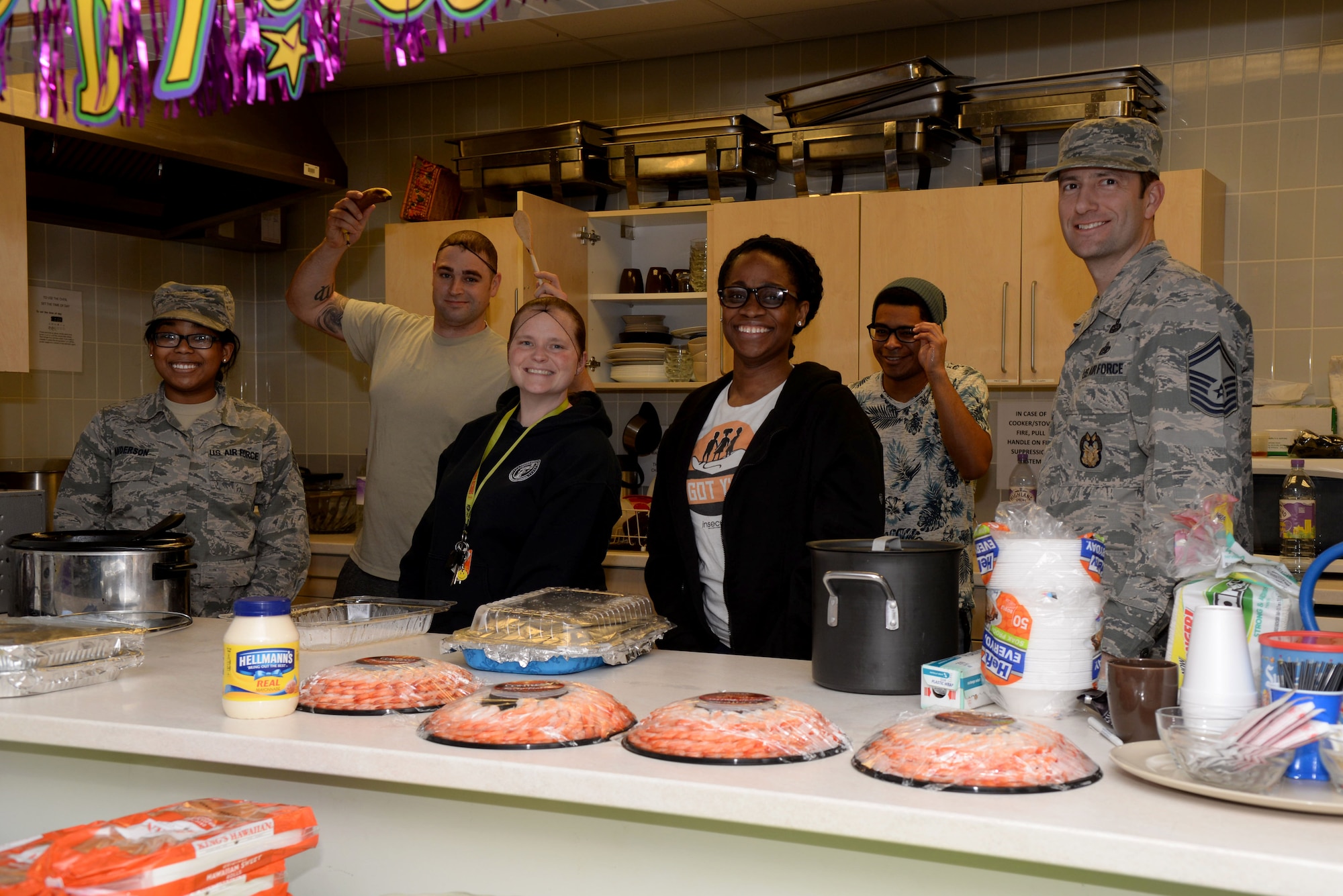 Volunteers from Team Mildenhall pose for a photograph during the Hearts Apart event Feb. 16, 2017, on RAF Mildenhall, England.  The monthly Hearts Apart dinners are a way for spouses and family members of deployed Airmen to gather together and connect.  (U.S. Air Force photo by Airman 1st Class Tenley Long)
