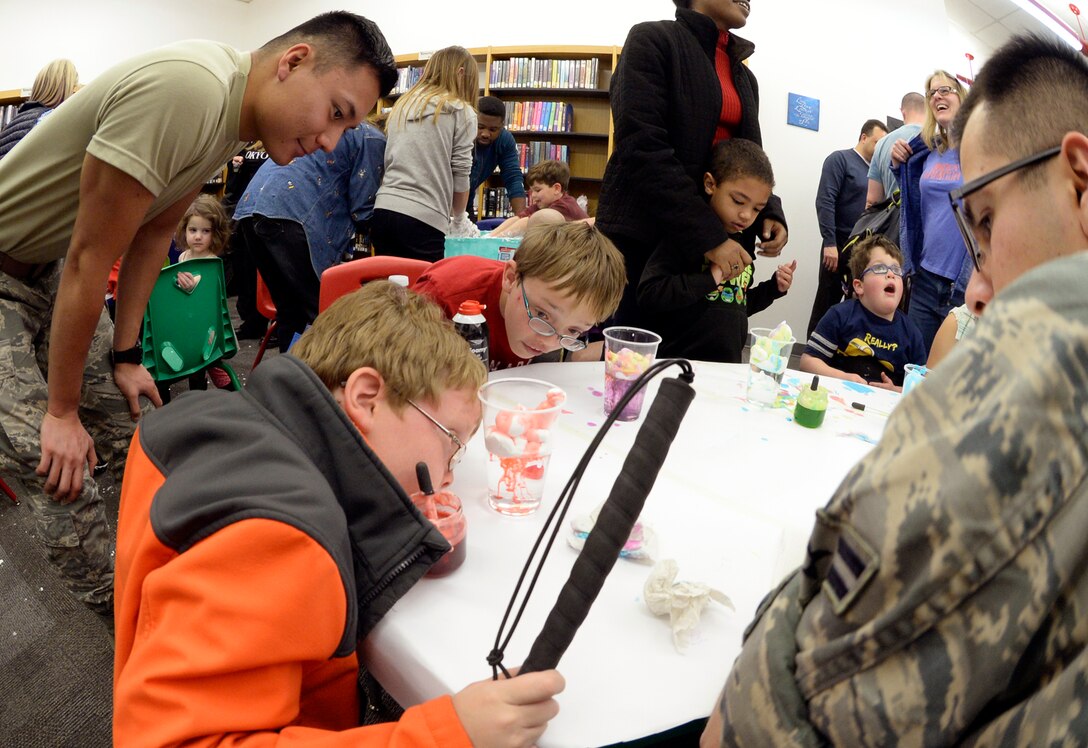 Children with special needs, their siblings and parents, and volunteers make rain clouds out of shaving cream during a STEM event Feb. 15, 2016 at the Hill Air Force Base, Utah. The library setting provided a stress-free environment for the children and their families to have new experiences, just like those enjoyed by typical children. (U.S. Air Force photo by Todd Cromar)