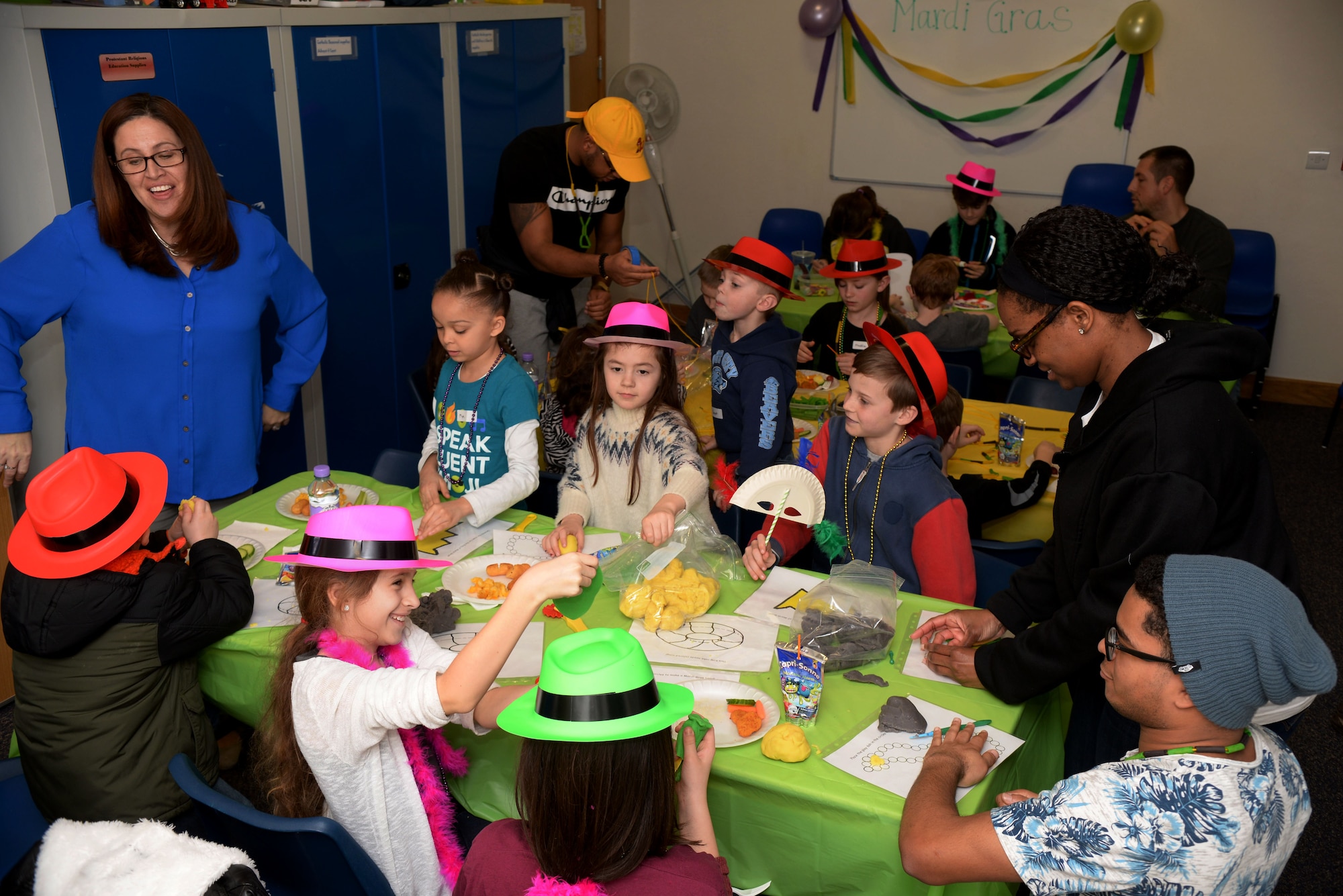 Volunteers from Team Mildenhall lead activities for the kids during the Hearts Apart event Feb. 16, 2017, on RAF Mildenhall, England. These activities included mask-and necklace-making to go along with the “Mardi Gras” theme. (U.S. Air Force photo by Airman 1st Class Tenley Long)