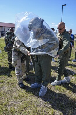 Citizen Airmen with the 920th Rescue Wing work together to decontaminate aircrew members processing through the aircrew contamination control area during the wing’s Mission Assurance Exercise Feb. 12 at Patrick Air Force Base, Fla. (U.S. Air Force photo/Senior Airman Brandon Kalloo Sanes)
