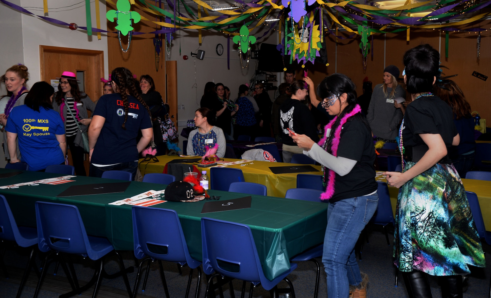 Members of Team Mildenhall socialize during the Hearts Apart event Feb. 16, 2017, on RAF Mildenhall, England. The Hearts Apart events are held monthly, and this month’s theme was “Mardi Gras,” complete with decorations and New Orleans-themed food. (U.S. Air Force photo by Airman 1st Class Tenley Long)