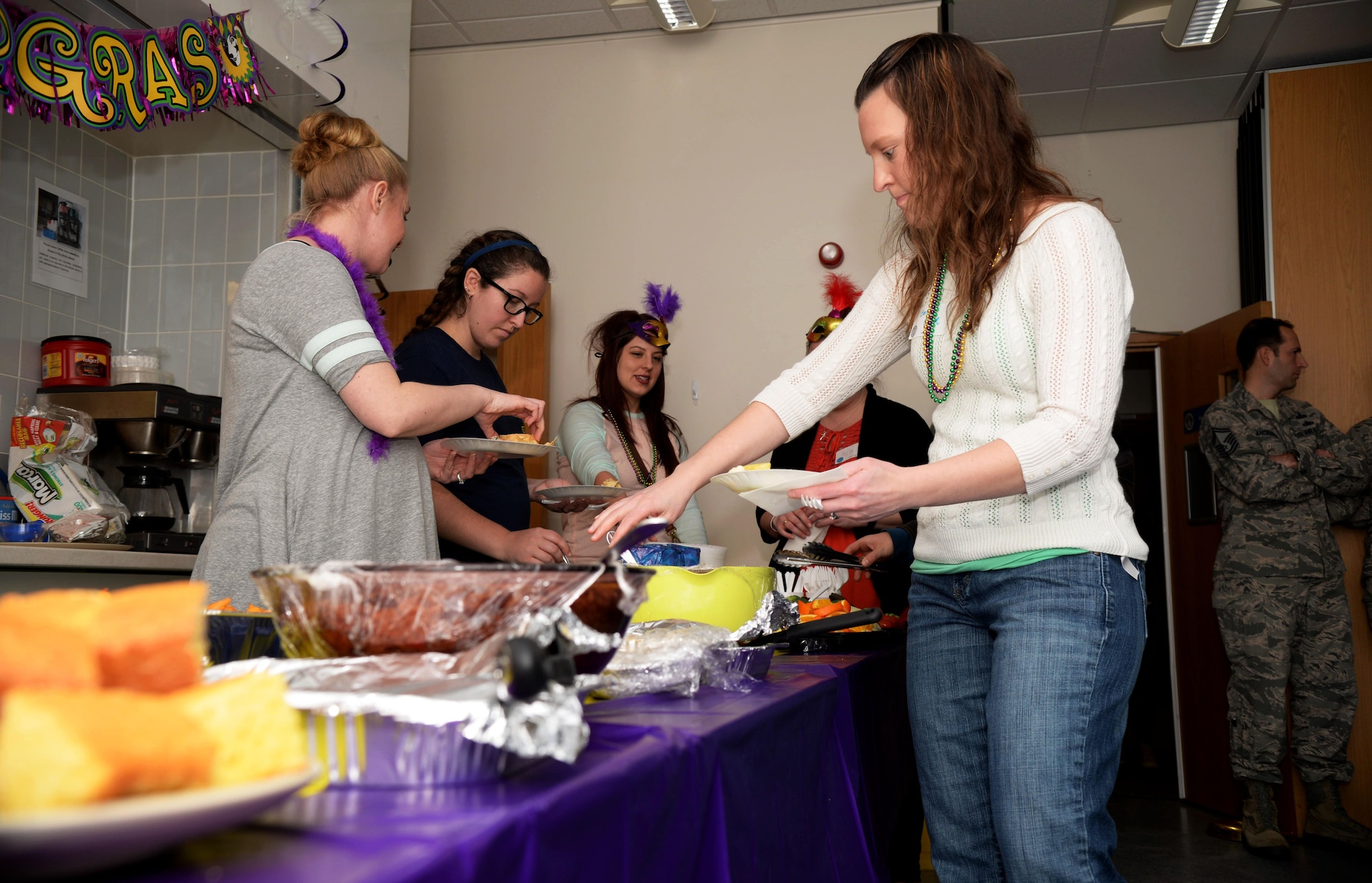 Attendees of the Hearts Apart event prepare their plates Feb. 16, 2017, on RAF Mildenhall, England. The Hearts Apart events are held monthly, and this month’s theme was “Mardi Gras.” Food included gumbo, shrimp and cornbread. (U.S. Air Force photo by Airman 1st Class Tenley Long)