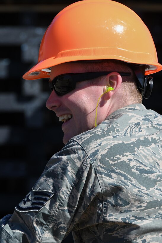 It is all smiles for an Airman after successfully completing a bag lift exercise at Barksdale Air Force Base, La, Feb. 16, 2017. More than 30 active-duty and reserve Airman, including several from the 307th Bomb Wing, 2nd Bomb Wing and Air Force Global Strike Command, worked together to perform the successful lift. The exercise simulates how an intact jet that has lost landing gear can be recovered. It is the first such exercise attempted with a B-52 in more than 30 years. (U.S. Air Force photo by Tech. Sgt. Ted Daigle/Release)