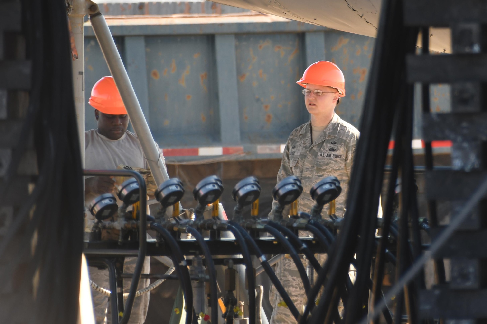 Two Airmen monitor air pressure gauges for a bag lift exercise at Barksdale Air Force Base, La., Feb. 16, 2017. A B-52 Stratofortress was lifted, for the first time since 1984, with large inflatable airbags to simulate how to recover a jet experiencing a landing gear failure. More than 30 Airmen from Barksdale, Sheppard and Edwards Air Force Bases participated in the exercise. (U.S. Air Force photo by Tech. Sgt. Ted Daigle/Released)