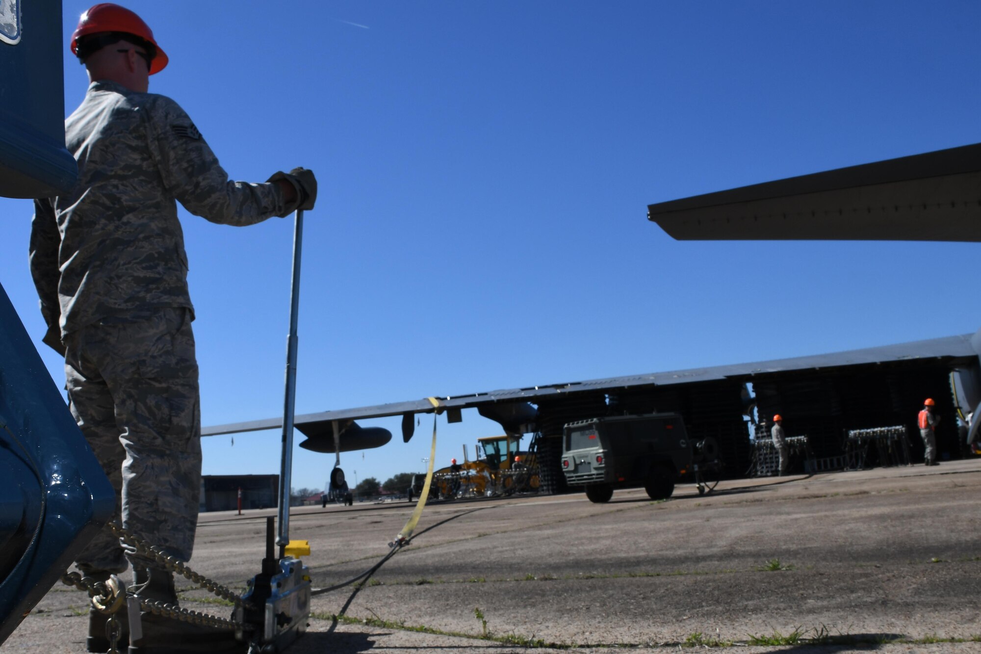 Large straps secure a B-52 Stratofortress during a bag lift exercise at Barksdale Air Force Base, La., Feb. 16, 2017. The jet, which has been inoperable since it was damaged in a fire, was the perfect candidate for the exercise. Such training helps Airmen learn how to recover a plane that has crashed or been rendered immobile due to faulty landing gear. (U.S. Air Force photo by Tech. Sgt. Ted Daigle/Released)