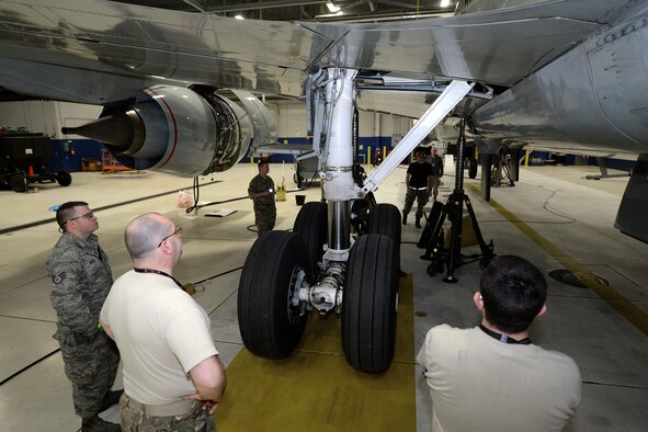 Royal Air Force 51 Squadron and 55th Maintenance Squadron maintenance personnel troubleshoot landing gear problems on a RAF RC-135 Airseeker suspended by 30 ton aircraft jacks inside a hangar at Offutt Air Force Base, Neb. Feb. 12. The aircraft diverted from Nellis Air Force Base to Offutt where it received maintenance assistance from the 55th MXG to correct a landing gear problem that occurred while participating in a joint exercise. (U.S. Air Force photo by Delanie Stafford)