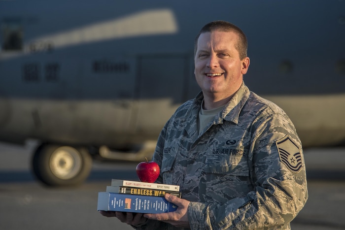 Air Force Master Sgt. Jason Paseur, the 386th Air Expeditionary Wing historian, poses for a photo in front of a C-130H Hercules aircraft during his deployment to Southwest Asia, Feb. 7, 2017. Paseur is a reservist deployed from Dobbins Air Reserve Base, Ga. and teaches history as a civilian. Air Force photo by Senior Airman Andrew Park