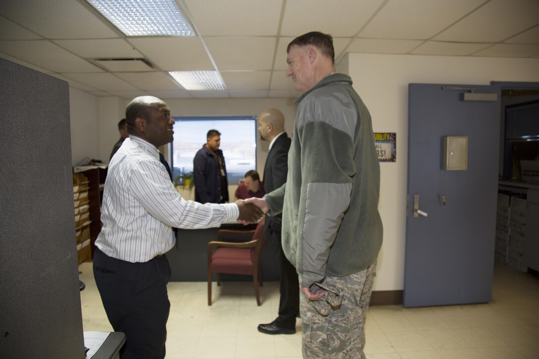 (Left) Nuhu Kashalla, Property Disposal Specialist, DLA Disposition Services, MCLBB; greets U.S. Air Force Lt. Gen. Andrew E. Busch, director, Defense Logistics Agency, during the general’s visit to West Coast DLA facilities that fall under his command from DLA headquarters at Fort Belvoir, Va., Jan. 26.