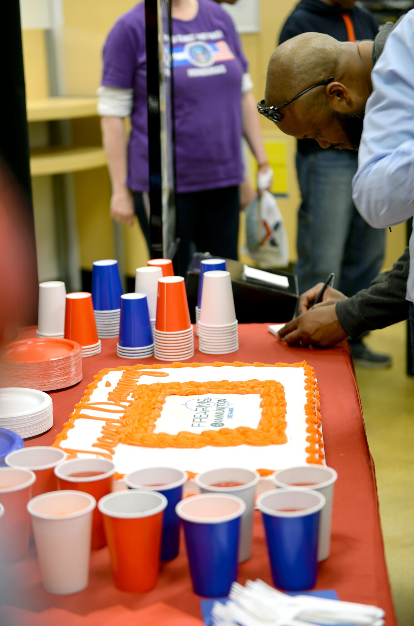 Cake and refreshments is provided to individuals during the grand opening of the Maxwell Base Exchange firearms counter, Friday, Feb. 17, 2017. Patrons could also enter to win a free firearm during the grand opening, as well as, receiving free firearm related apparel. (U.S. Air Force photo/Senior Airman Tammie Ramsouer)