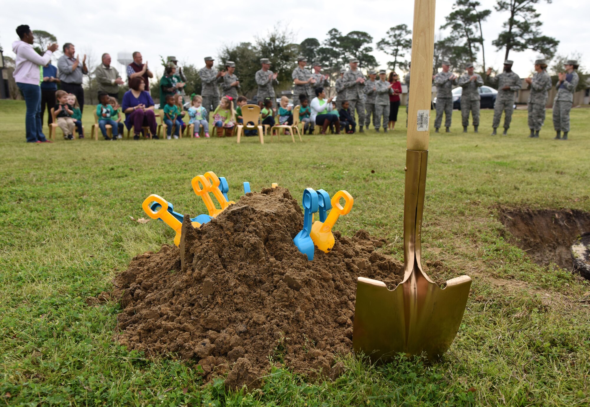 Children from the child development center and 81st Training Wing  leadership attend an Arbor Day celebration outside of the CDC Feb. 14, 2017, on Keesler Air Force Base, Miss. Keesler AFB earned the national Tree City USA honor from the Arbor Day Foundation for its 24th consecutive year. The children help wing leadership with the tree planting ceremony. (U.S. Air Force photo by Kemberly Groue)