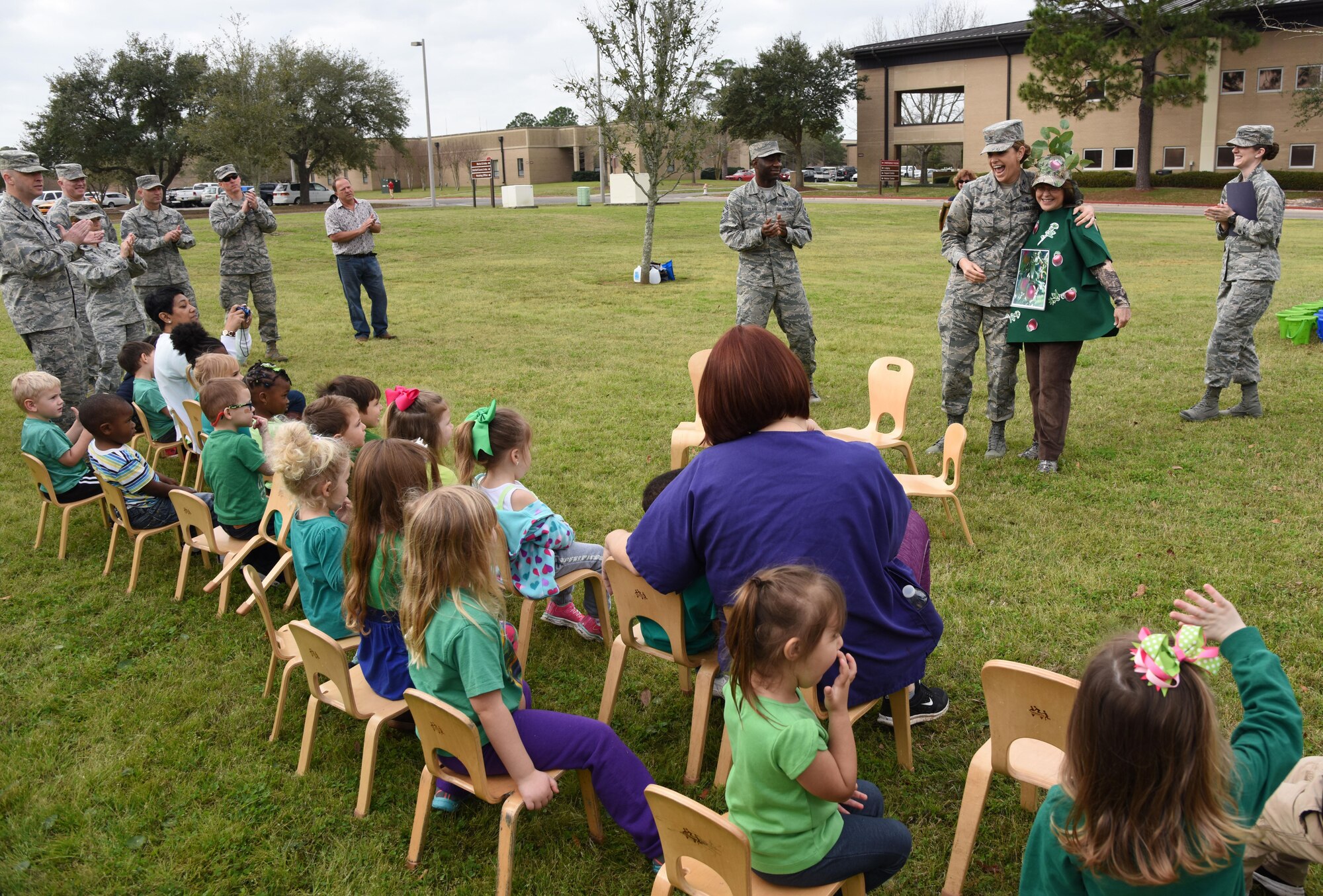 Col. Michele Edmondson, 81st Training Wing commander, hugs “Leafy” the apple tree during an Arbor Day celebration outside the child development center Feb. 14, 2017, on Keesler Air Force Base, Miss. Keesler AFB earned the national Tree City USA honor from the Arbor Day Foundation for its 24th consecutive year. (U.S. Air Force photo by Kemberly Groue)