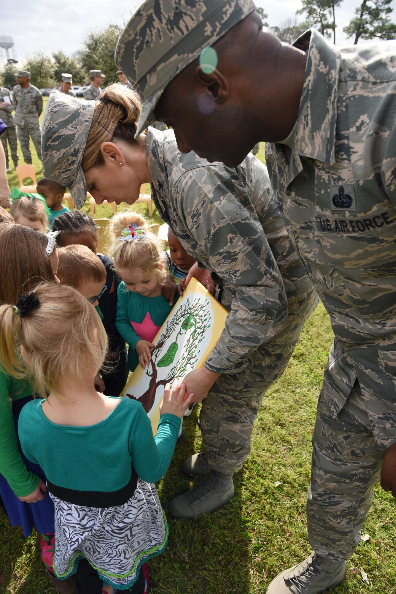 Col. Michele Edmondson, 81st Training Wing commander, and Chief Master Sgt. Vegas Clark, 81st TRW command chief, receive a presentation from children from the child development center at an Arbor Day celebration outside of the CDC Feb. 14, 2017, on Keesler Air Force Base, Miss. Keesler AFB earned the national Tree City USA honor from the Arbor Day Foundation for its 24th consecutive year. (U.S. Air Force photo by Kemberly Groue)