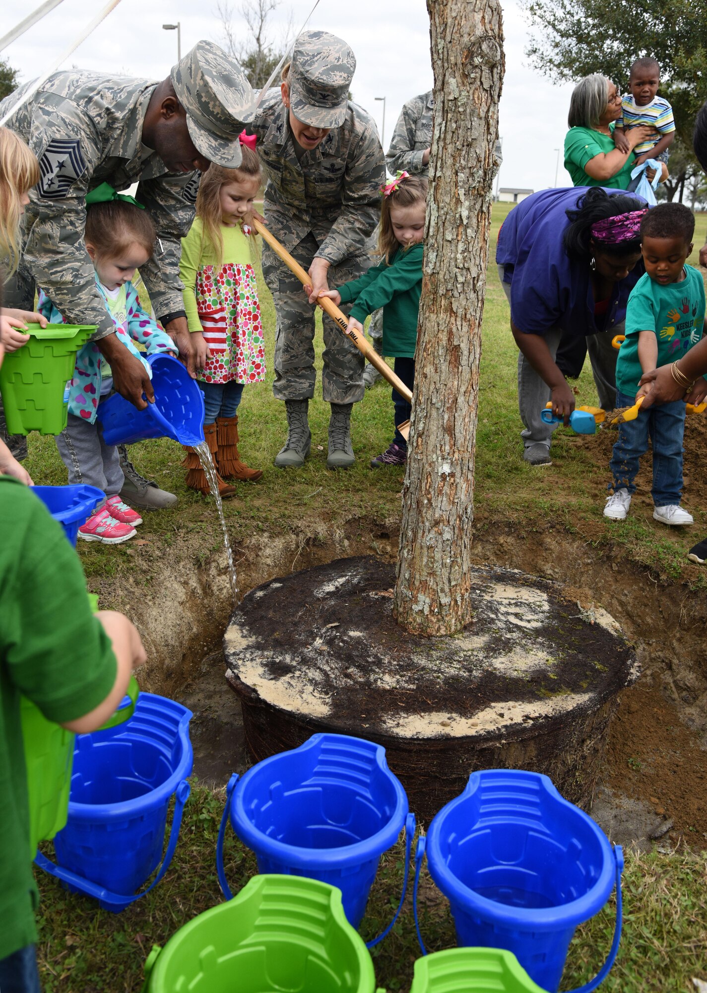 Col. Michele Edmondson, 81st Training Wing commander, and Chief Master Sgt. Vegas Clark, 81st TRW command chief, help children from the child development center plant a tree outside of the CDC during an Arbor Day celebration Feb. 14, 2017, Keesler Air Force Base, Miss. Keesler AFB earned the national Tree City USA honor from the Arbor Day Foundation for its 24th consecutive year. (U.S. Air Force photo by Kemberly Groue)