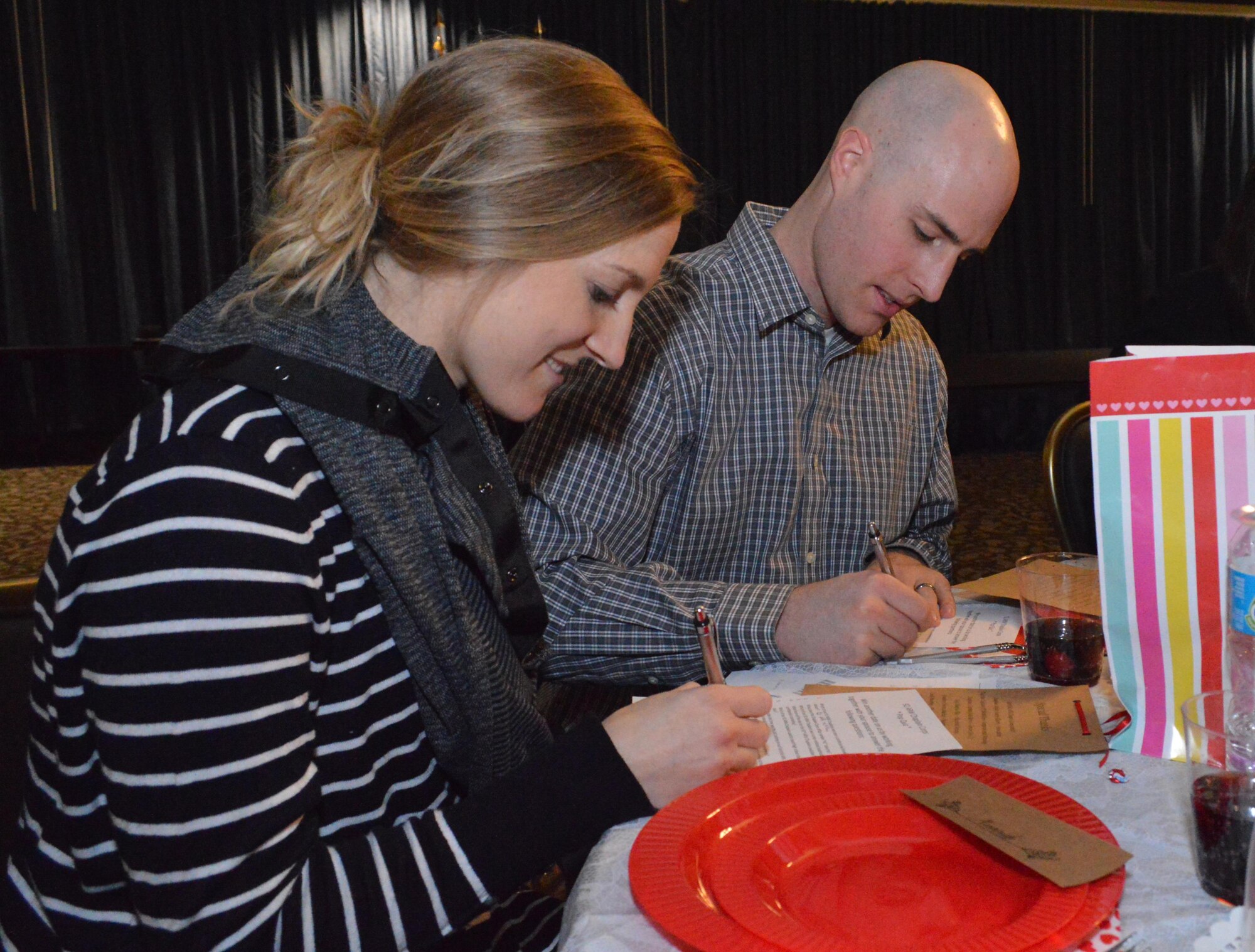 A couple fills out a “pop quiz” during the Sweetheart Dinner marriage enrichment event, Feb. 11, 2017, at the Red Morgan Center on Fairchild Air Force Base, Washington. The event, which featured a catered dinner and dessert, ballroom dance lessons, an inspirational message, special music, a photo booth and marriage resources, was free for the attendees and was paid for solely by the Chapel’s tithes and offerings fund. (Courtesy Photo/Kristina Liapis)