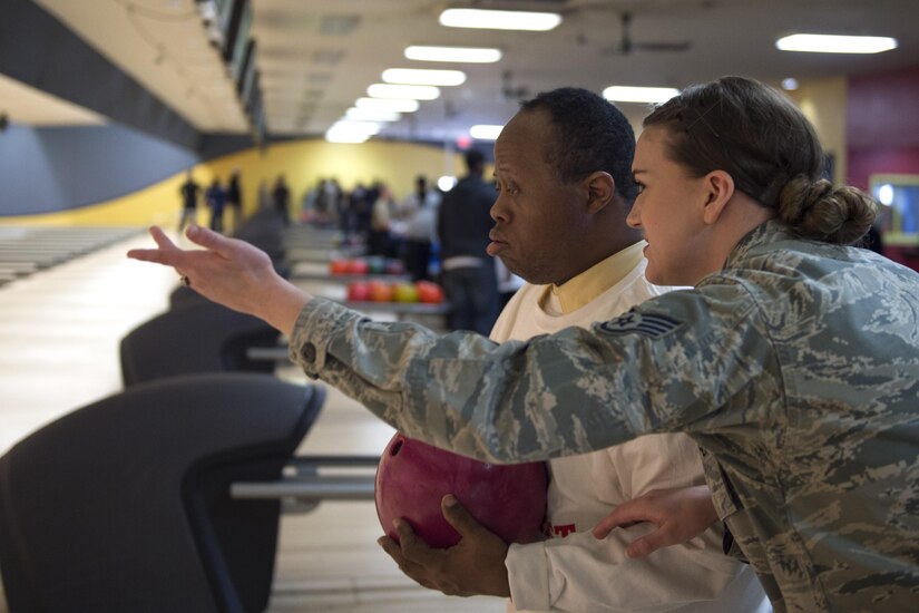 Staff Sgt. Kristen McDonald, 89th Arial Port Squadron security manager, assists Byron Harris, District of Columbia Special Olympics athlete, during the 2017 D.C. Special Olympics Bowling Championship at Hyattsville, Md., Feb. 16, 2017. Volunteers were encouraged to help with equipment, keep score, get to know the athletes and cheer them on throughout the tournament. (U.S. Air Force photo by Senior Airman Philip Bryant)