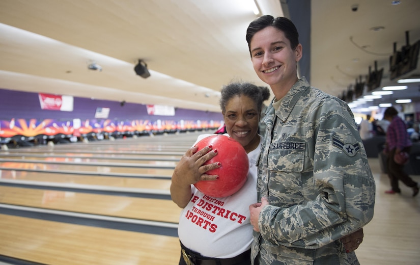 Airman 1st Class Autumn Payne, 779th Medical Support Squadron medical logistics personnel, smiles with her arm around Tina Johnson, District of Columbia Special Olympics athlete, during the 2017 D.C. Special Olympics Bowling Championship at Hyattsville, Md., Feb. 16, 2017. It was the largest military supported D.C. Special Olympics Bowling Championship with approximately 75 athletes and more than 70 military volunteers. (U.S. Air Force photo by Senior Airman Philip Bryant)