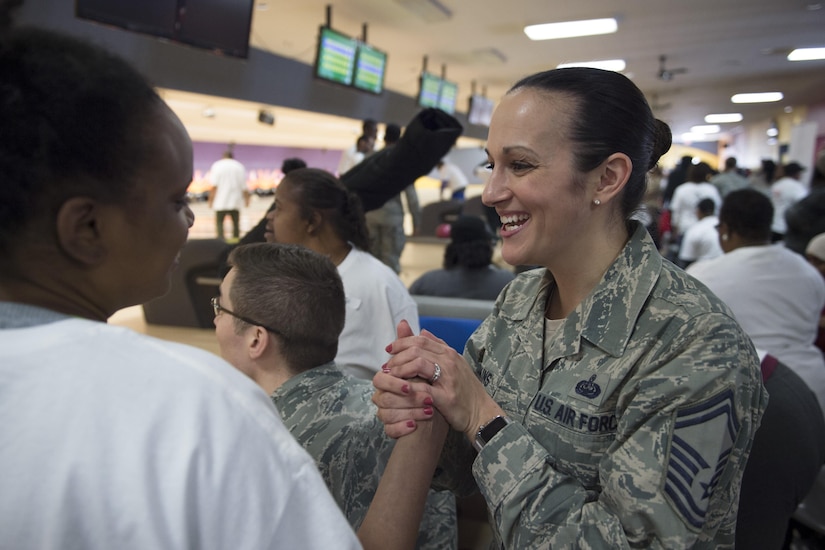 Senior Master Sgt. Frances Perkins, 89th Communications Squadron mission systems flight superintendent, smiles and embraces a Special Olympics athlete at the end of the 2017 D.C. Special Olympics Bowling Championship at Hyattsville, Md., Feb. 16, 2017. Volunteers were encouraged to help with equipment, keep score, get to know the athletes and cheer them on throughout the tournament. (U.S. Air Force photo by Senior Airman Philip Bryant)